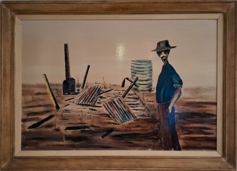 Painting of an elderly man in a blue shirt and dark hat standing beside the burnt remains of a rural house, with corrugated iron, posts and debris scattered across dry ground.